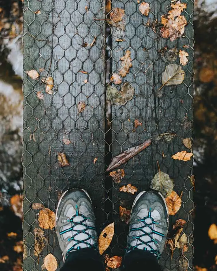 A pair of walking shoes on a wooden walkway
