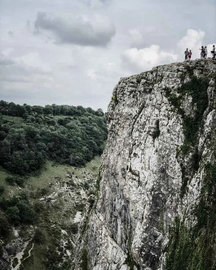 people standing at the top of cheddar gorge walks cliff top walk