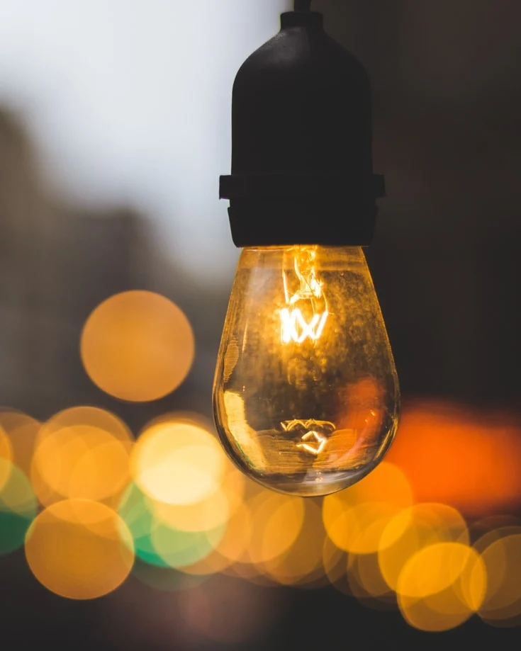 Close up of a lightbulb with bokeh light effects in the background