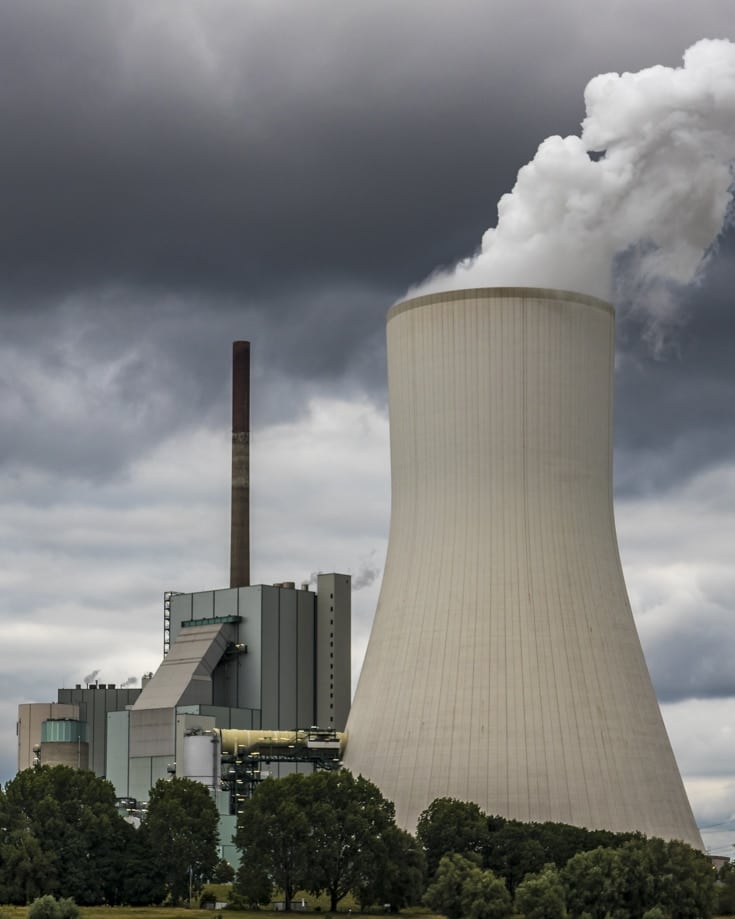 Smoke billowing from an electricity cooling plant chimney