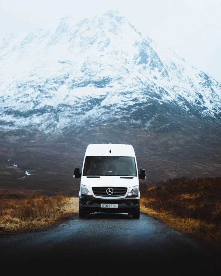 Motorhome or campervan in front of snow covered Scottish Highlands