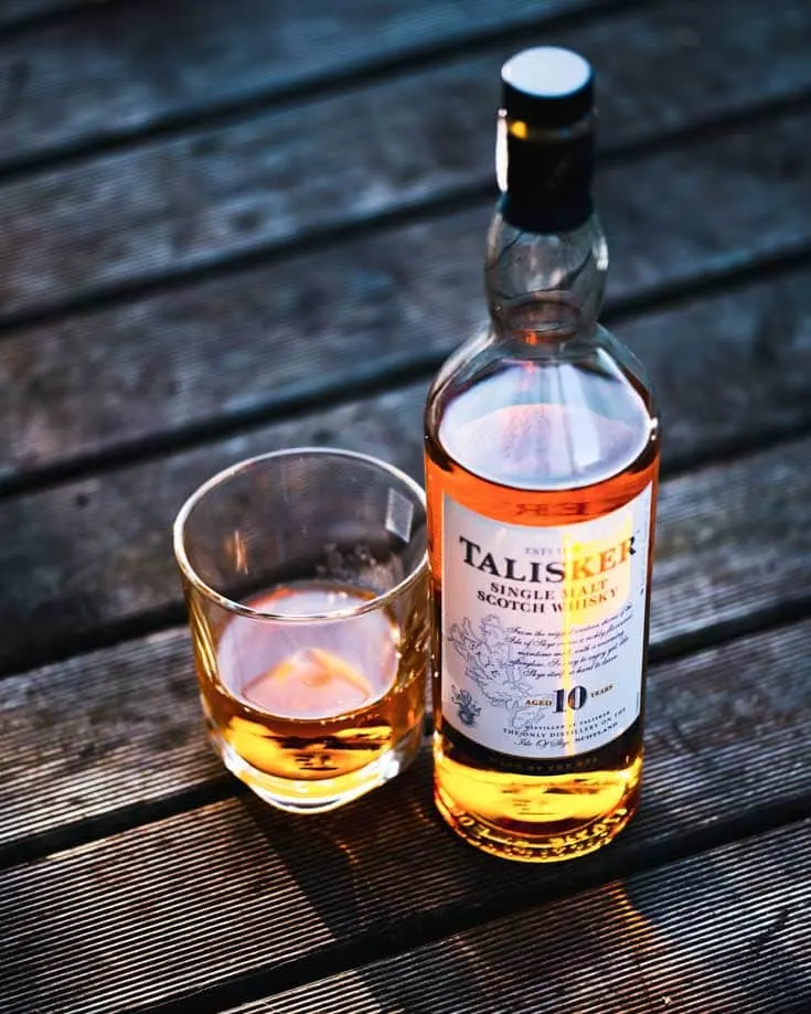 A bottle of Talisker whisky & a tumbler