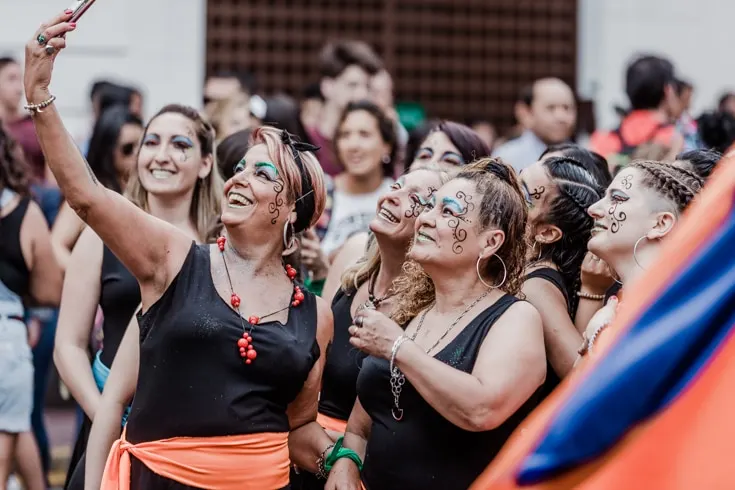 A group of female Candombe dancers in costume taking a selfie