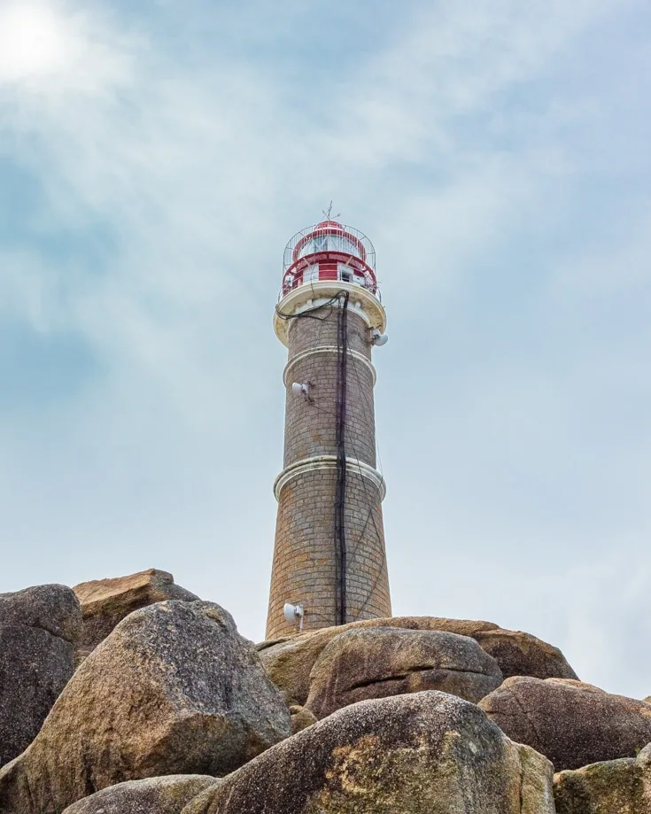 Looking up at the lighthouse on top of the rocks at Cabo Polonio Uruguay