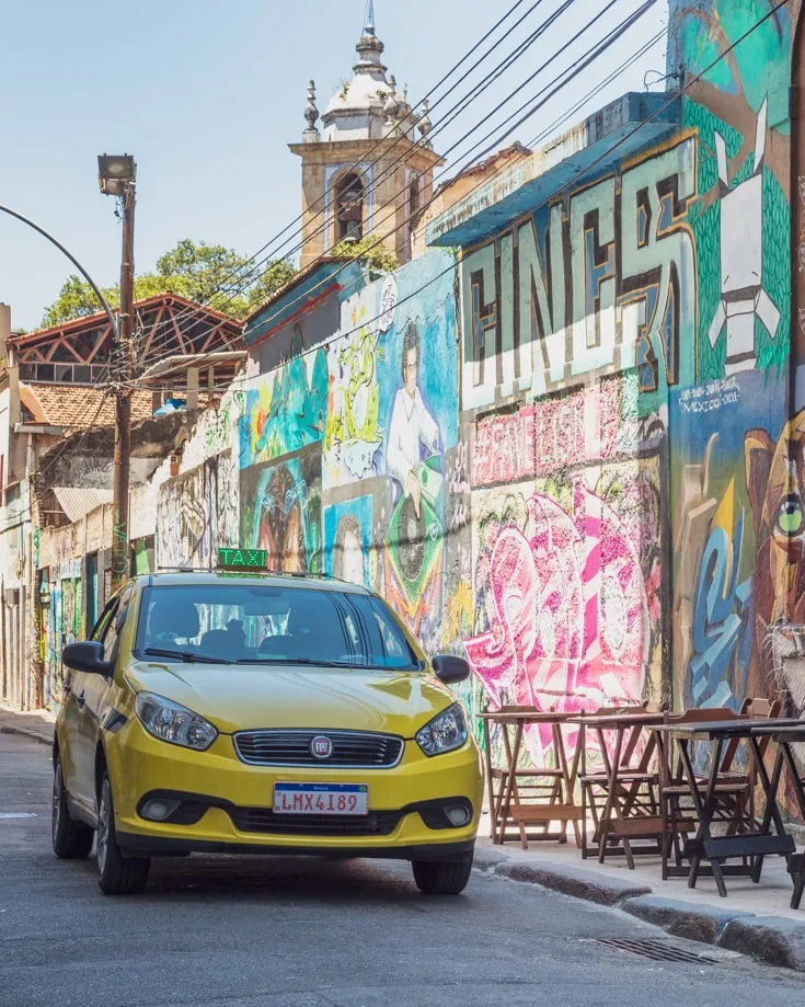 A taxi driving through the graffiti painted streets of Rio de Janeiro 
