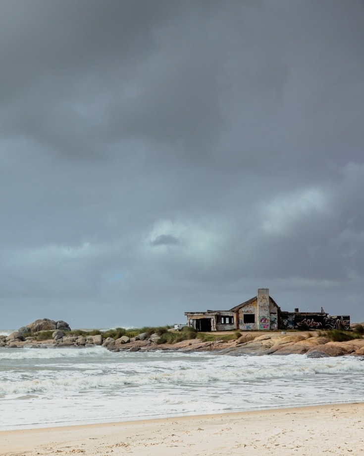 Dark storm clouds over an abandoned building on a beach in winter in Uruguay
