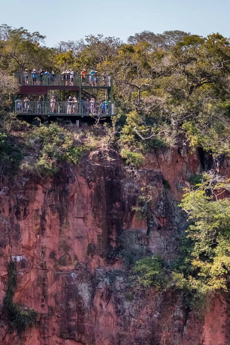 One of the viewing platforms with visitors looking into a sinkhole in Brazil's Buraco das Araras