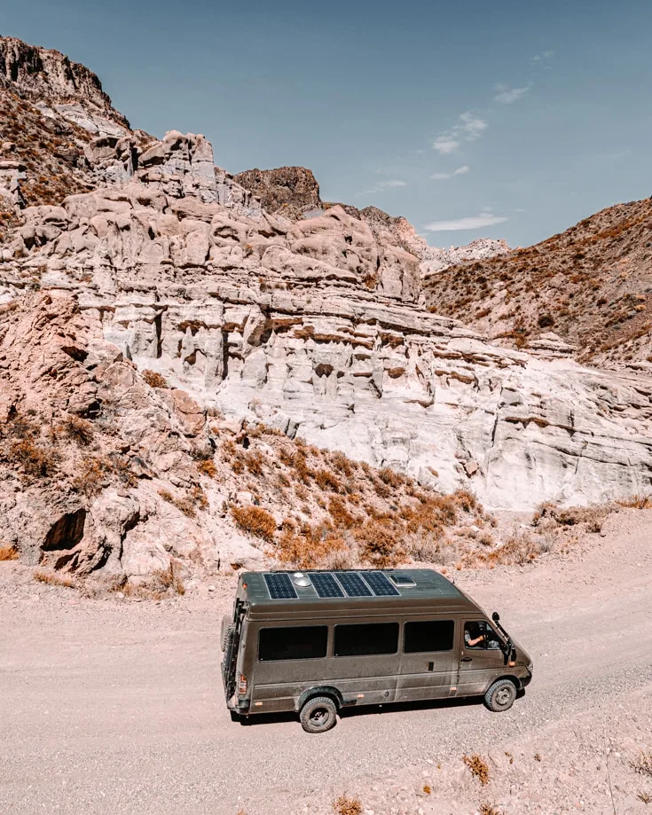 Rock formations in Atuel Canyon with sprinter camper van driving past
