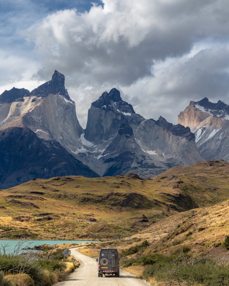 Camper van driving towards Los Cuernos in Torres del Paine National Park, Patagonia