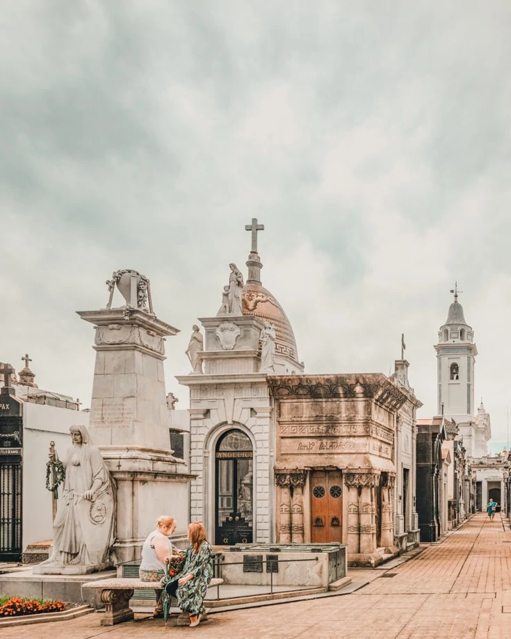 People sitting on a bench in Recoleta cemetery Buenos Aires