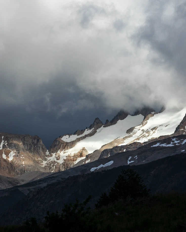 sunlight hitting th emountain peaks near cerro castillo in chilean patagonia