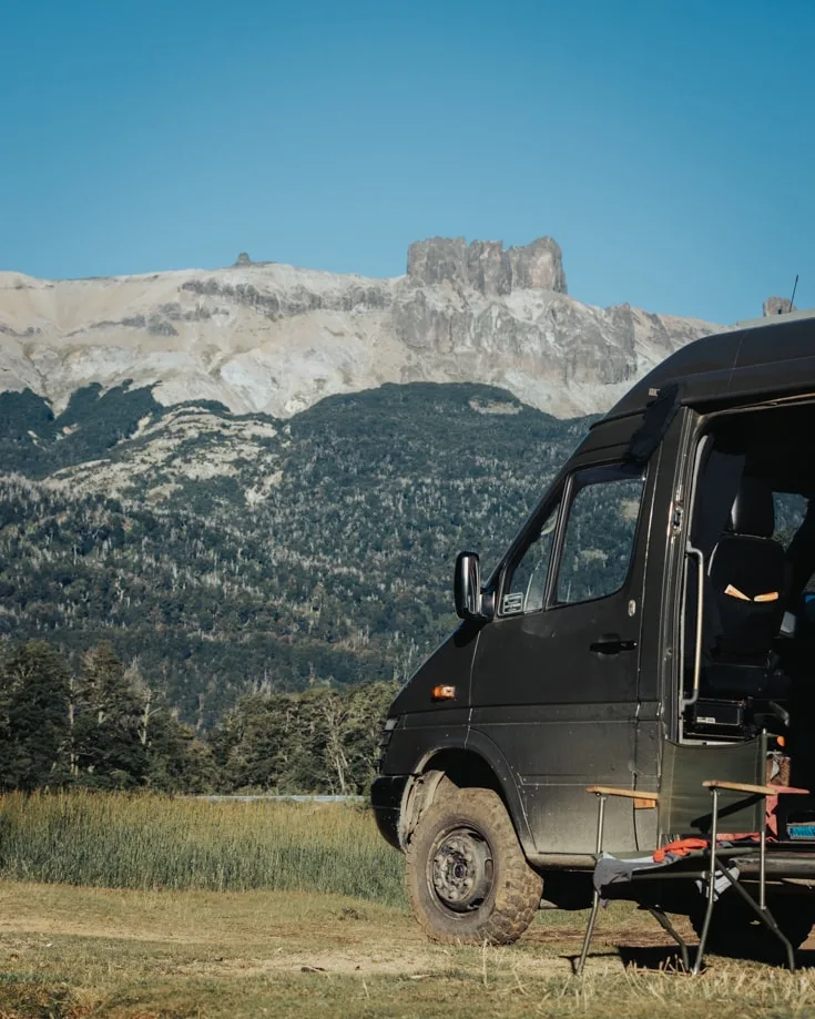 Sprinter van parked in front of mountains