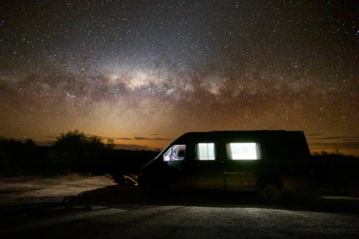 Milky way over a camping sprinter van conversion