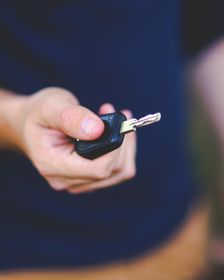 A person holding a car key