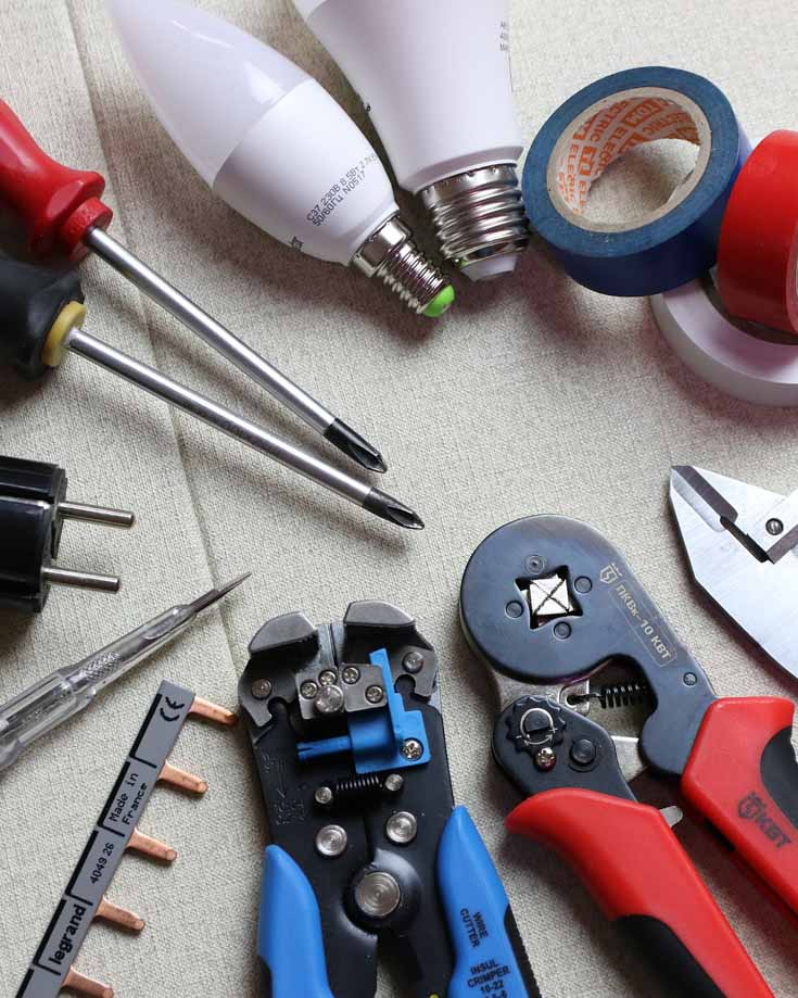 overhead photo of electrical tools laid out on a table