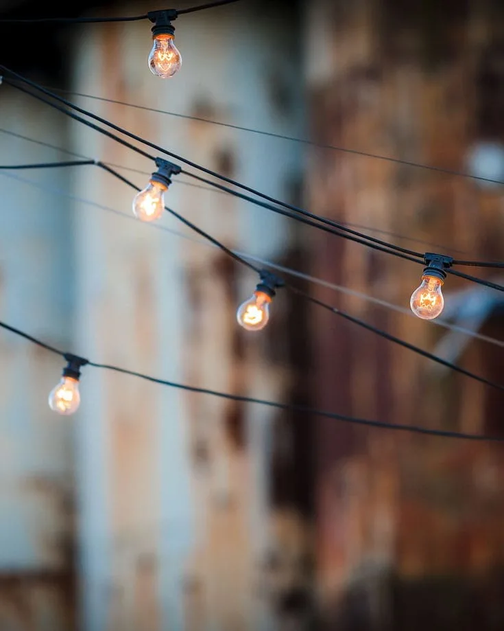 string of light bulbs hanging across a street