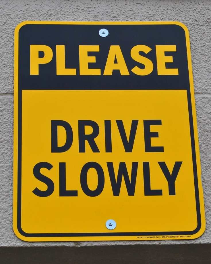warning sign to drive slowly