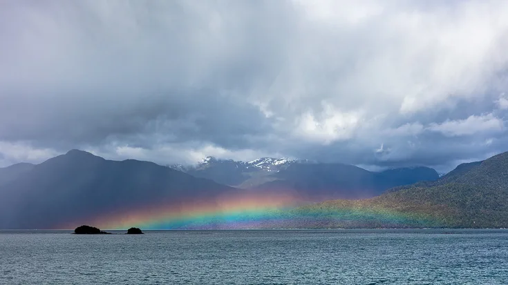 Rainbow over the fjords in Queulat National Park