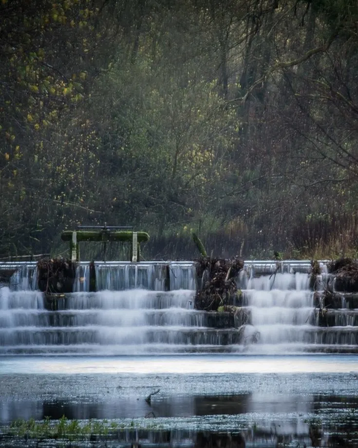Water falling through the weirs on the River Lathkill, Peak District