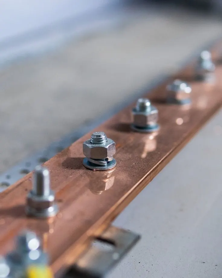 close up of a copper busbar and studs