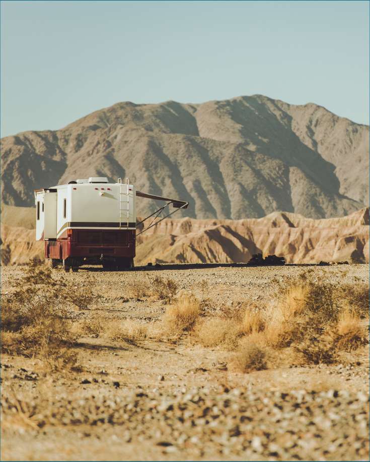 n RV in a remote desert landscape, showcasing the possibilities of dry camping and boondocking with a reliable RV battery.