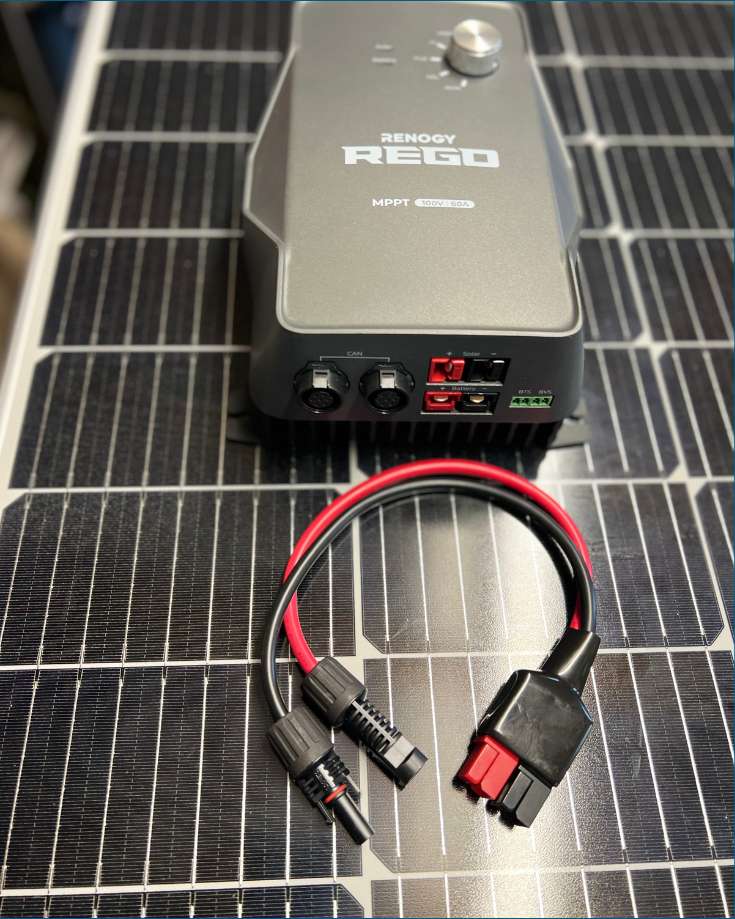 A close-up view of a Rego Renogy Solar Charge Controller, showing the Anderson connectors.