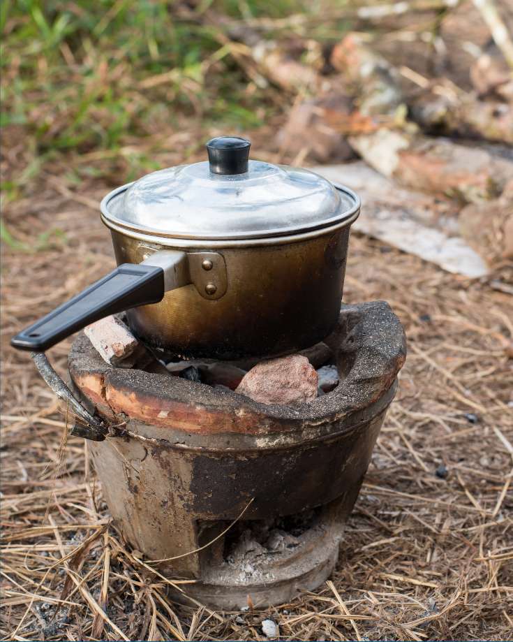 A hearty chili simmering in a Dutch oven, with steam rising and a wooden spoon ready for serving.