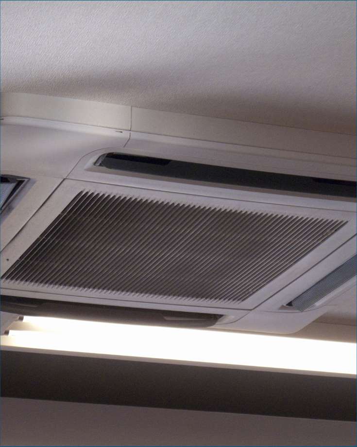 RV air conditioner with open cover, ready for maintenance.
