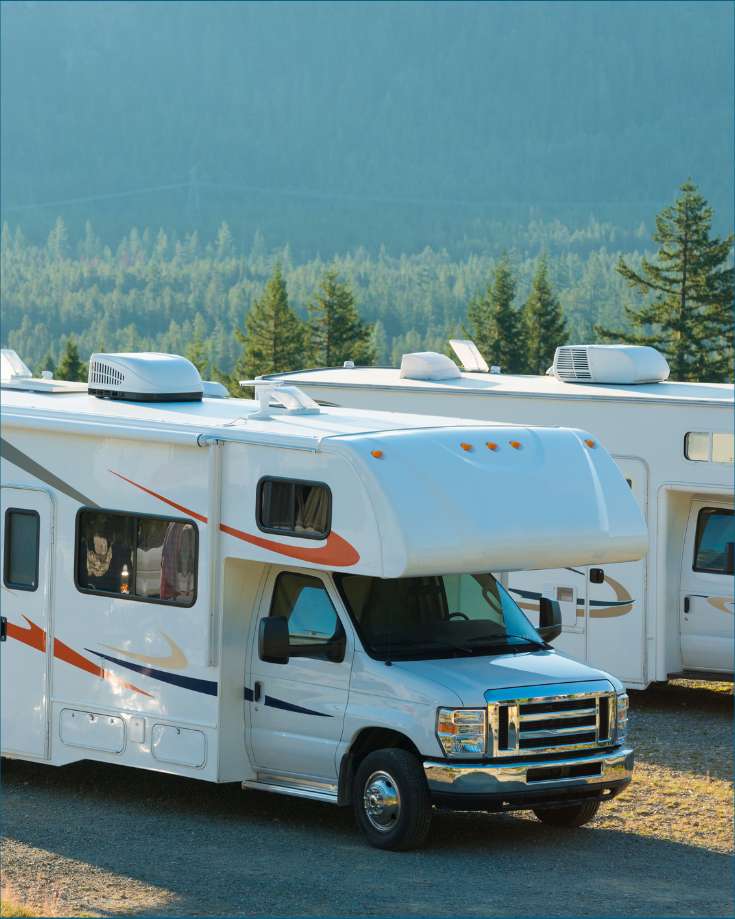 RV parked at a campsite with a smoothly running air conditioner