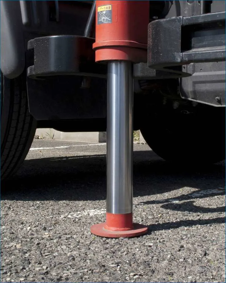 Close-up of a hydraulic RV leveling jack in action