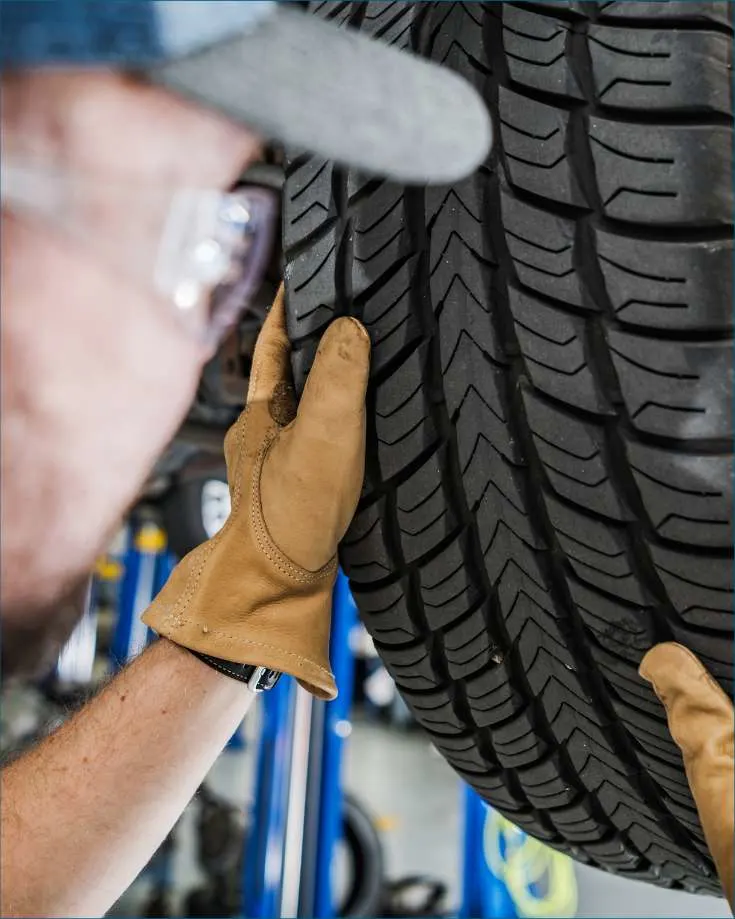 RV owner inspecting their vehicle's tires, emphasizing regular tire checks.