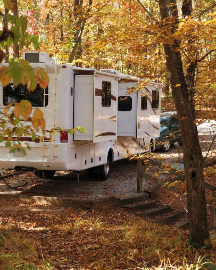 RV nestled in autumn foliage, cozy inside with an electric heater